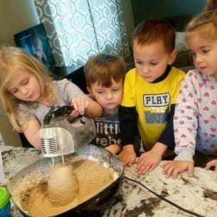 Kids mixing cookies for a USDA approved breakfast
